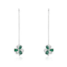Pair of emerald earrings on a white background