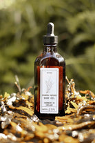Bottle of body oil with a dropper on a natural background