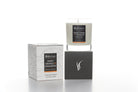 Candle and packaging with 'Sweet Orange & Cinnamon' label on a white background