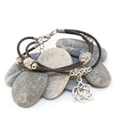 Bracelet with stone-like beads and Celtic knot charm on a white background