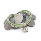 Green bracelet with a heart charm on stones