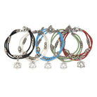 Set of five colorful bracelets with Celtic knot charms on a white background
