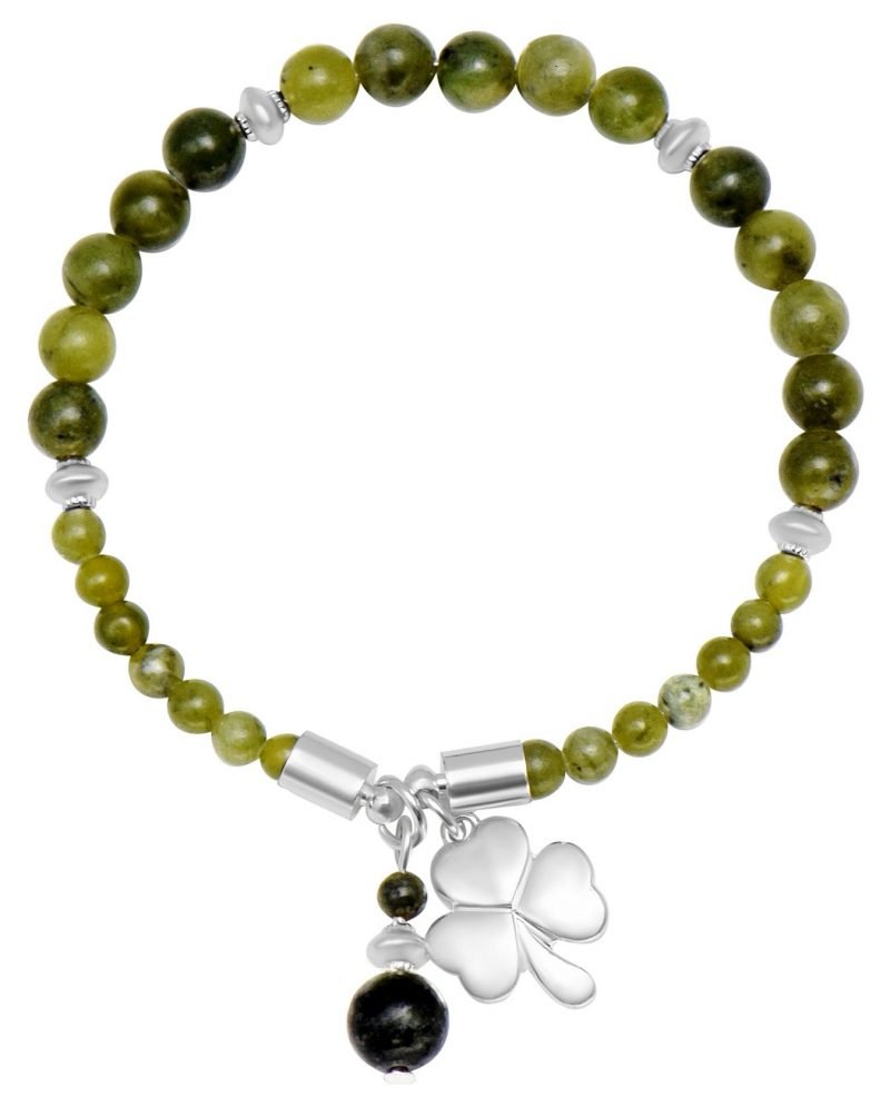 Bracelet with green beads and a silver clover charm on a white background
