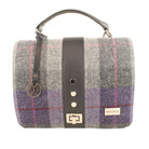 Plaid handbag with leather strap and visible brand logo on a white background