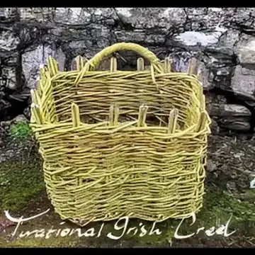 Woven basket with 'National Irish Craft' text against a stone wall background
