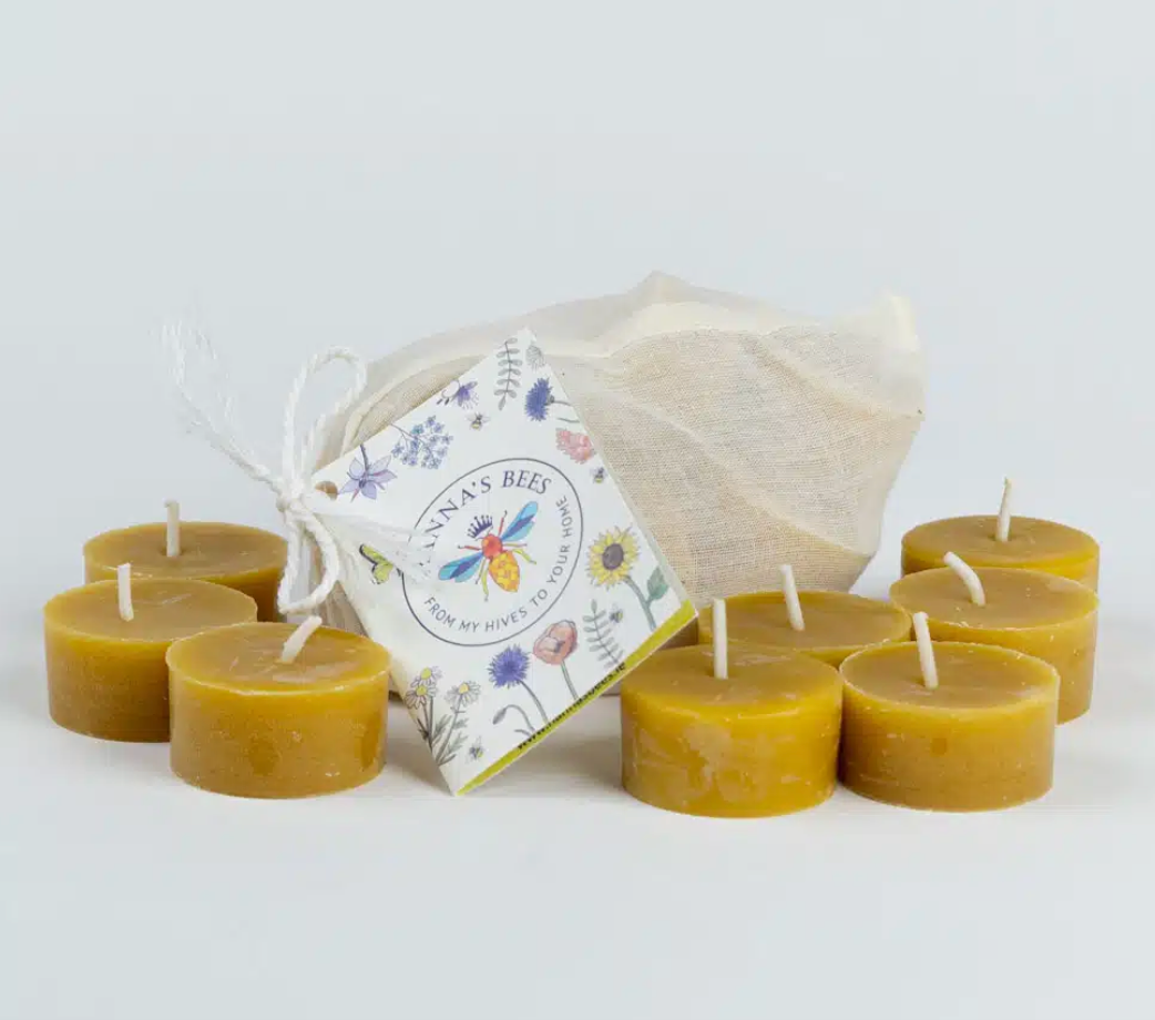 Beeswax candles with a branded bag on a white background