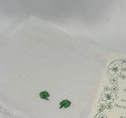 Small green shamrock wedding wish hanky  design on a white fabric with floral patterns.