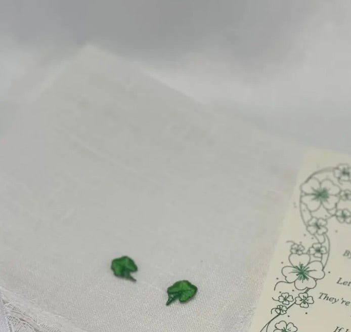Small green shamrock wedding wish hanky  design on a white fabric with floral patterns.