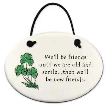 Round ceramic plaque with shamrocks and humorous friendship quote on a white background