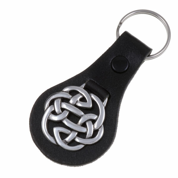 Keychain with Celtic knot design on a black leather strap against a white background