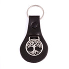Black leather keychain with silver tree of life design on a white background