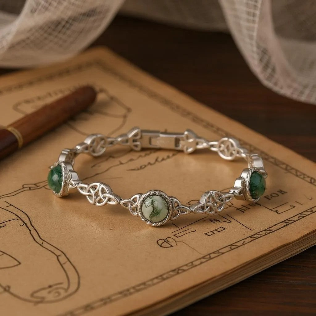 Silver bracelet with green stones on an old book