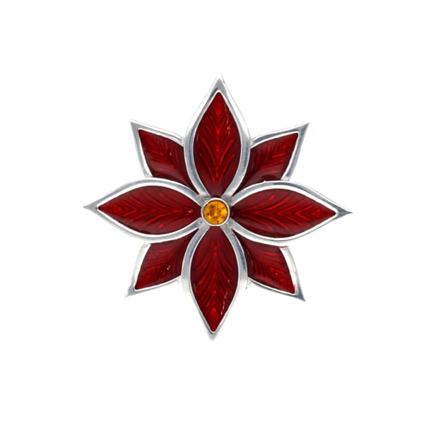 Red poinsettia brooch yellow center on a white background