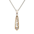 A silver and gold pendant necklace featuring a silver chain and a teardrop-shaped pendant with gold filigree details and a small clear diamond at the bottom.