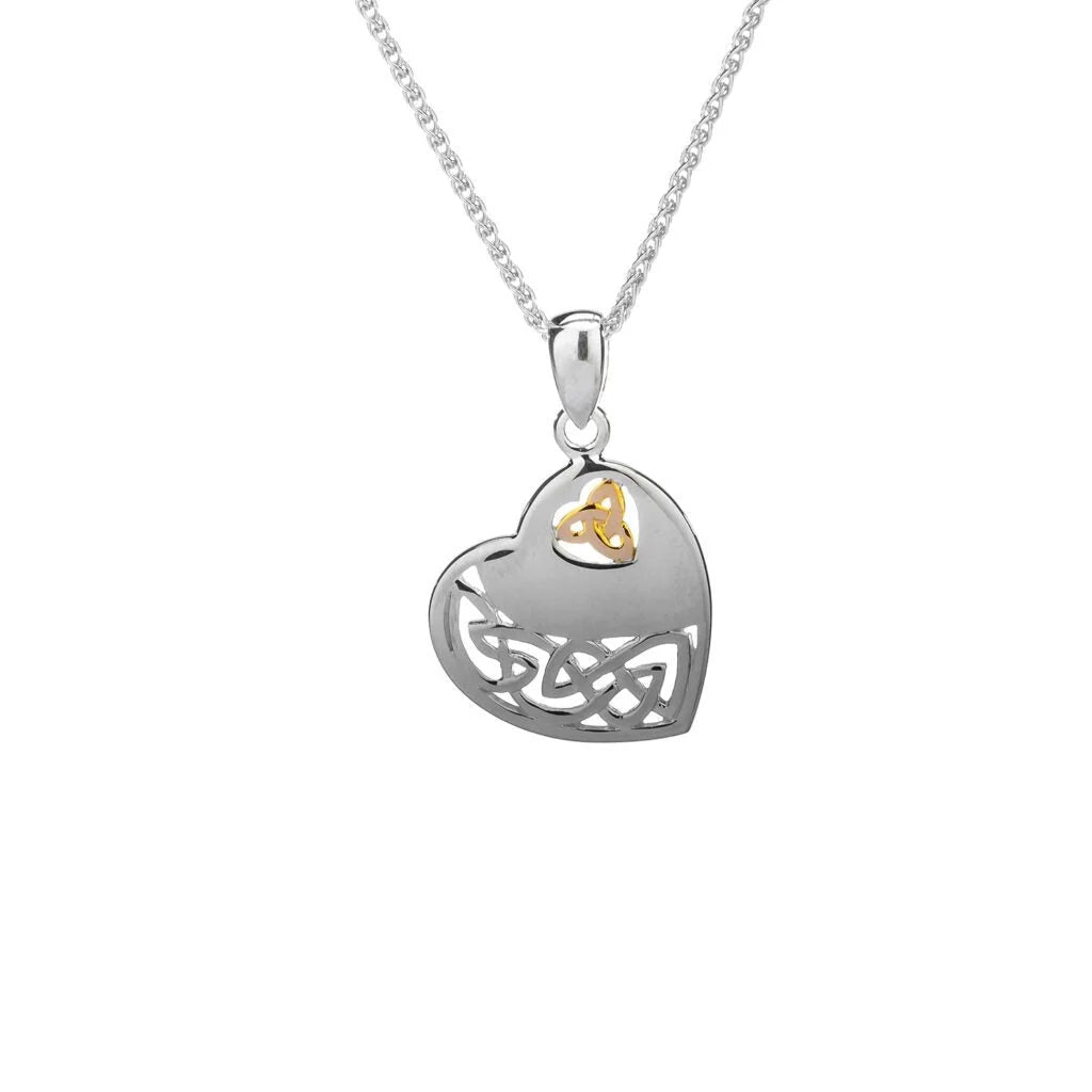 A silver heart-shaped pendant necklace with a Celtic knot design and a small gold triquetra symbol at the top, shown on a white background.