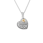 A silver heart-shaped pendant necklace with a Celtic knot design and a small gold triquetra symbol at the top, shown on a white background.