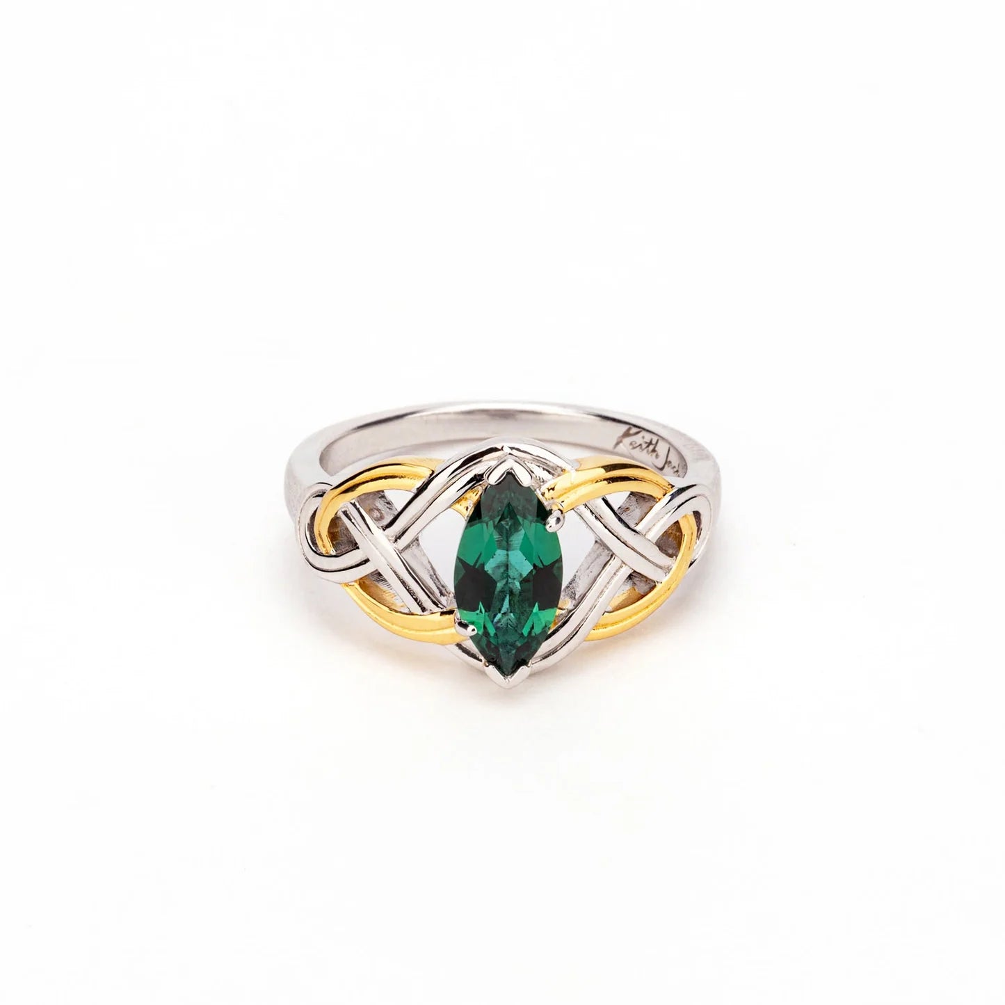 A two-tone sterling silver and yellow gold ring featuring a marquise-cut green emerald gemstone at the center, set against a plain white background.