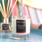 Candle labeled 'Wild Scottish Raspberry' by Highland Soap Co. with a blurred background