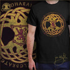 Black t-shirt with gold and red emblem and text, worn by a person, with a decorative background featuring similar design elements.  Scottish rampant lion symbol.