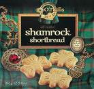Box of O'Neill's shamrock shortbread with decorative elements on a plaid background