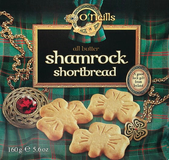 Box of O'Neill's shamrock shortbread with decorative elements on a plaid background