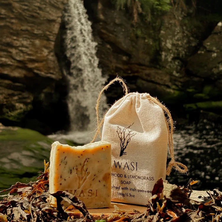 WASI wood and lemon grass seaweed soap with packaging in a natural setting
