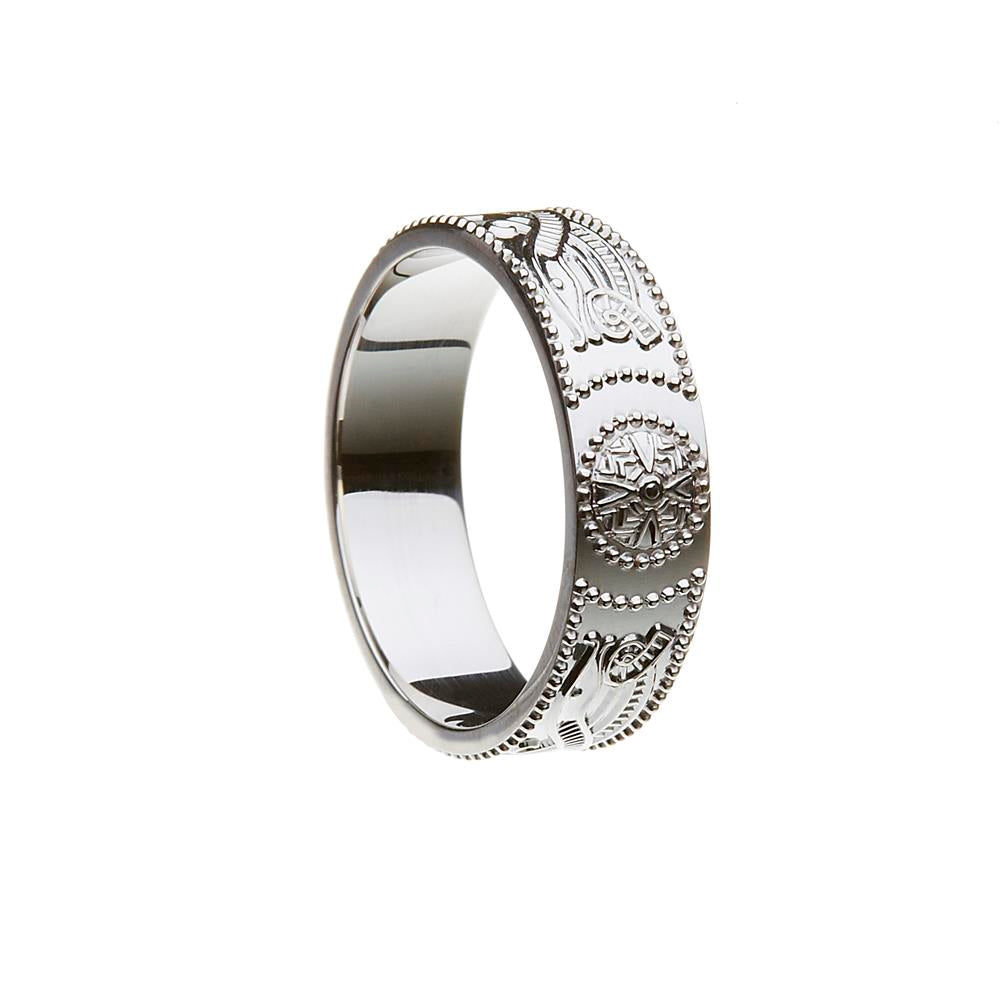 Silver ring with intricate designs on a white background
