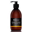 Brown bottle of Whisky & Honey hand and body organic lotion with a pump on a white background