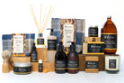 Collection of products including soap & lotion bottles, candles, and a brush on a white background.