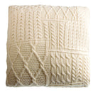 Knitted blanket with cable pattern on a white background