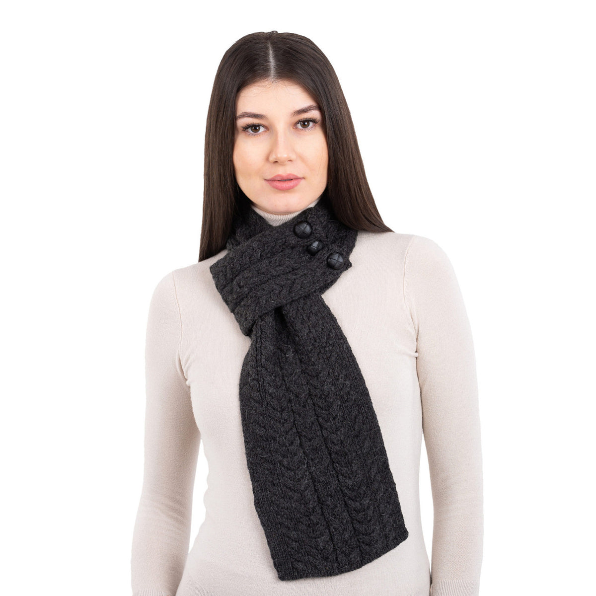 Woman wearing a dark gray knitted scarf with buttons on a white background