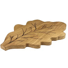 Wooden cutting board shaped like a leaf with engraved branch design on a white background