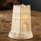 Decorative stone tower candle holder on a wooden surface