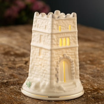 Decorative stone tower candle holder on a wooden surface