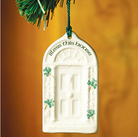 Decorative ornament with 'Bless this house' text and shamrocks on a brown background