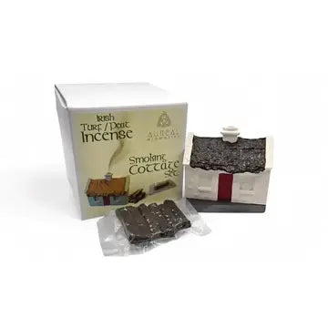 Aushall Smoaking Cottage Irish Turf & Peat Incense set, featuring a white box, a miniature cottage-shaped incense holder, and several incense sticks in a clear plastic packet on a white background.