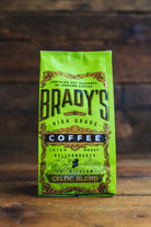Green coffee bag labeled 'Brady's High Grade Coffee' on a wooden surface