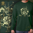 Green t-shirt with gold musical instrument design worn by a person, with a similar design in the background.