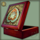 Decorative wooden box with intricate design on a light green background