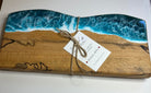 Wooden board with ocean design and a tag on a white background