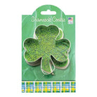 Shamrock cookie cutter in packaging with green background