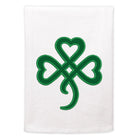 Green shamrock design tea-towel on a white towel