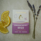 Enniskinn aromatherapy wax melts packaging with lemon slices and lavender on a neutral background