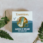 Enniskinn Garden of Ireland Irish Seaweed Soap packaging on a textured surface with green leaves.