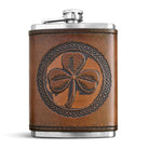 Brown leather flask with a shamrock design on a white background