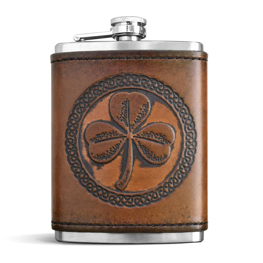 Brown leather flask with a shamrock design on a white background