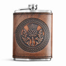 Brown leather flask with embossed design on a white background