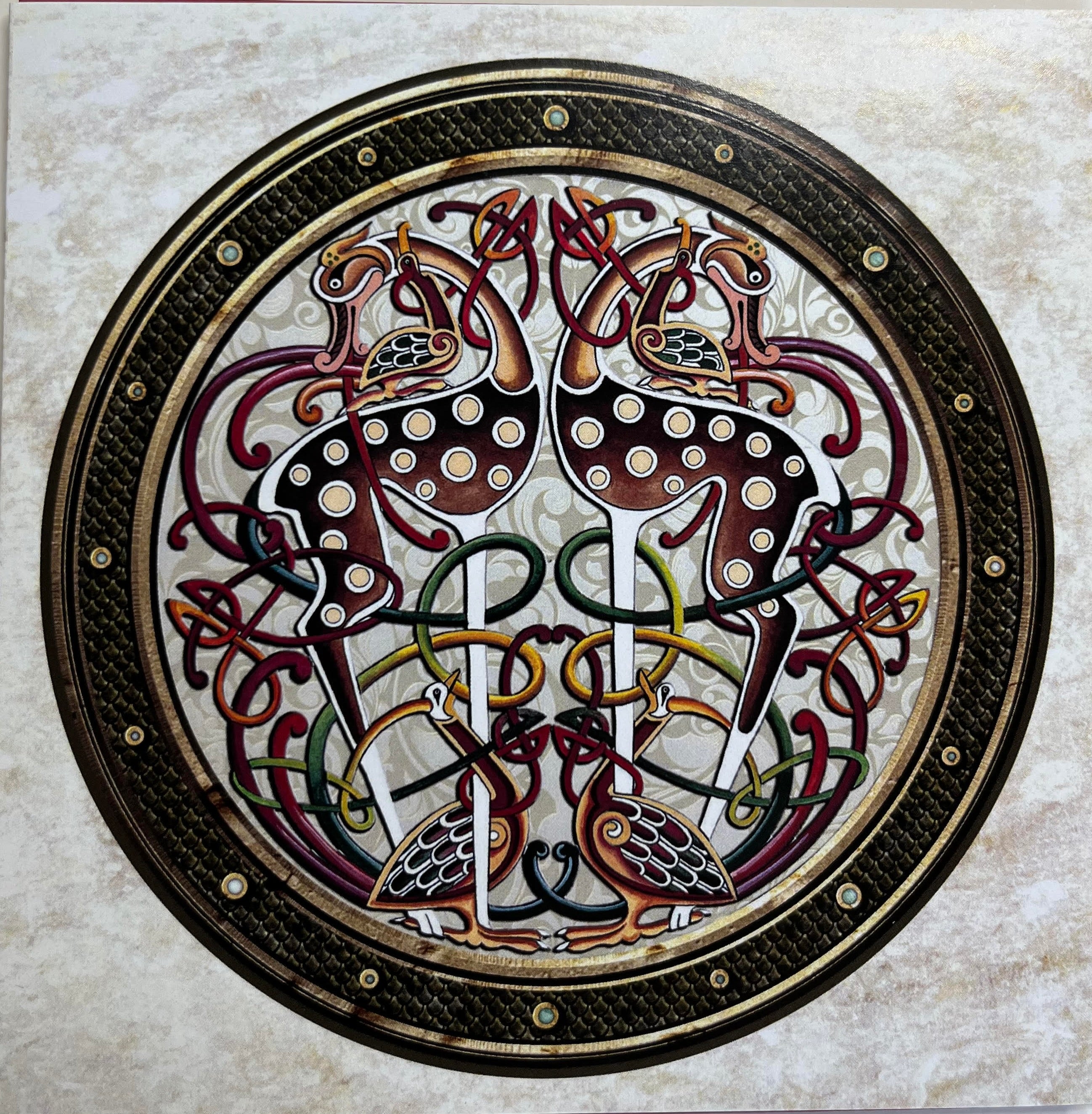 Decorative circular design with intricate patterns on a marble background
