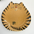 Cat-shaped plate with black stripes on a white background