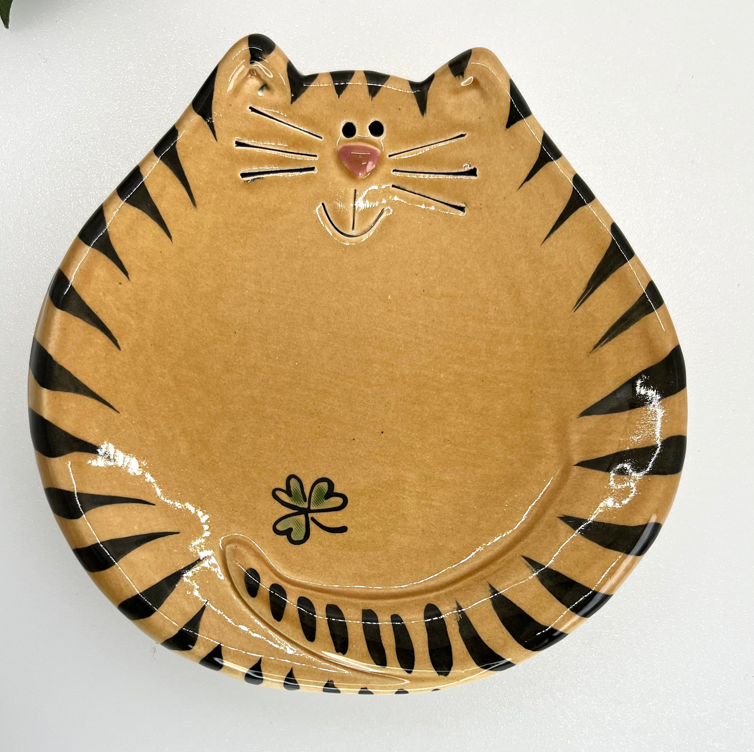 Cat-shaped plate with black stripes on a white background